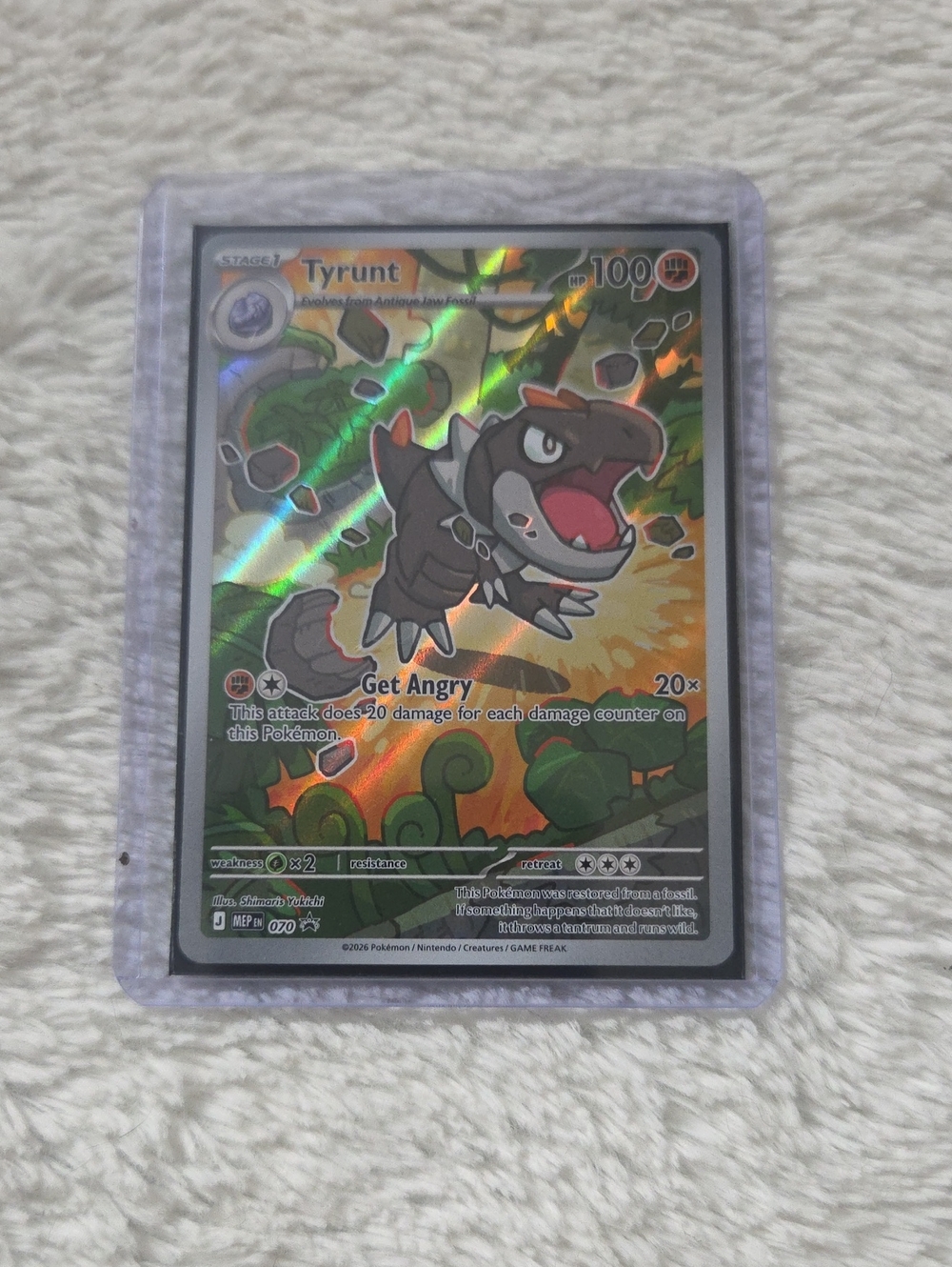 Full-art illustration card is the Tyrunt Black Star Promo (#070) POR